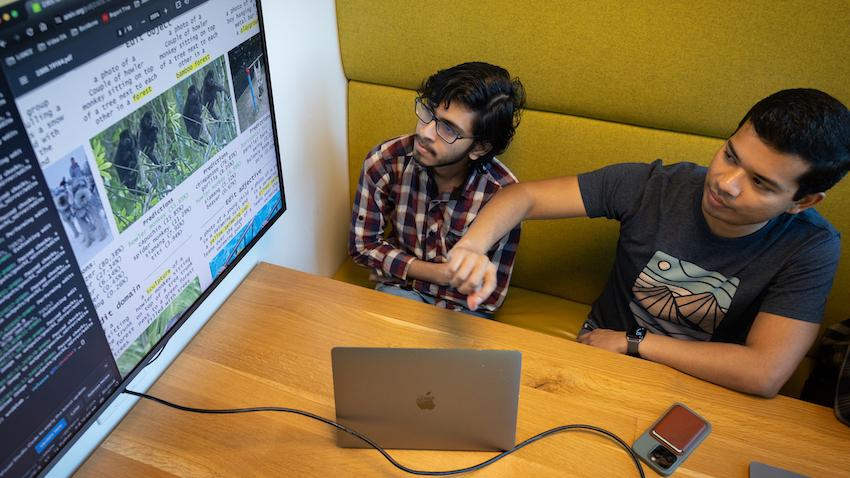 Two students looking at screen