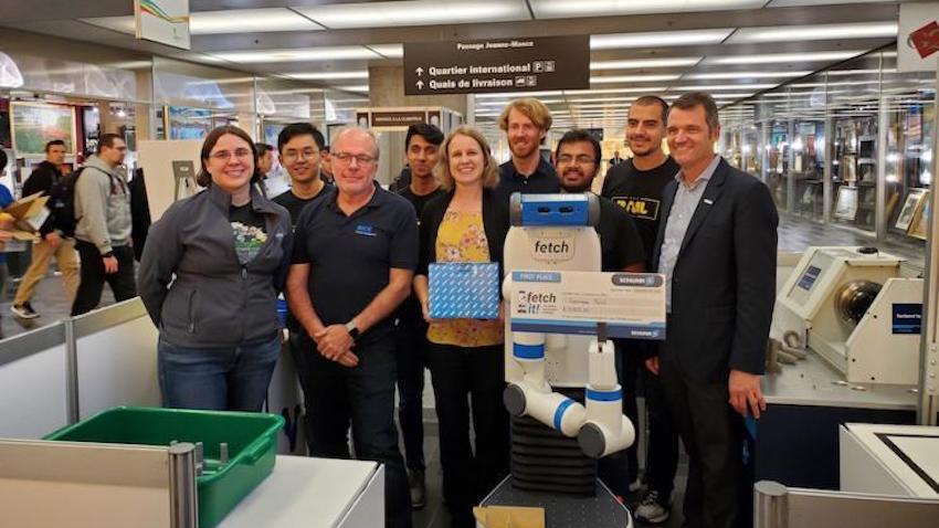 A team of roboticists poses after winning the Fetch Robotics Fetch It Challenge